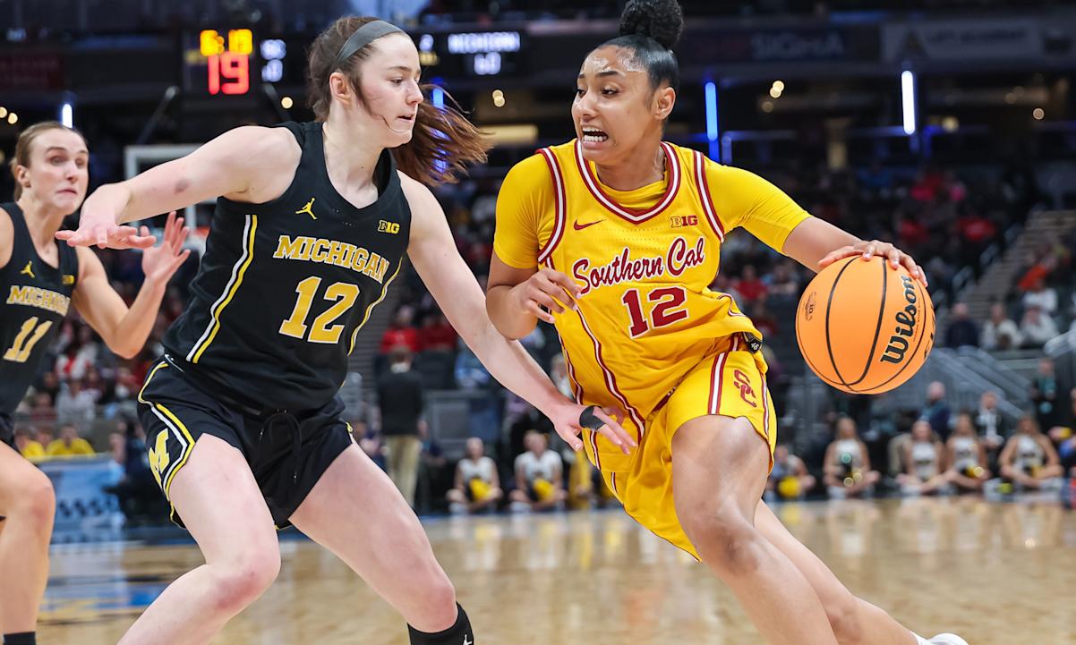 JuJu Watkins #12 of the USC Trojans drives to the basket against Syla Swords #12 of the Michigan Wolverines