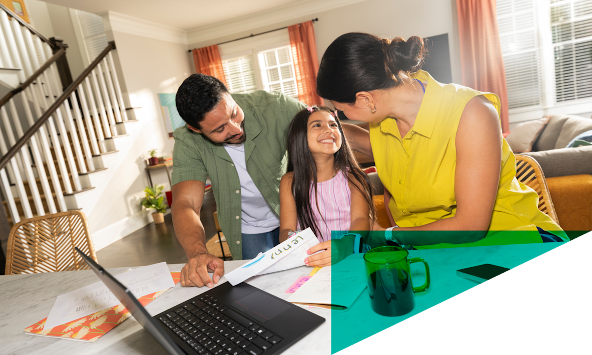 family at table with laptop