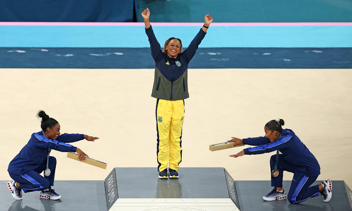 Gold medalist Rebeca Andrade (C) of Team Brazil, silver medalist Simone Biles (L) of Team United States and bronze medalist Jordan Chiles (R)