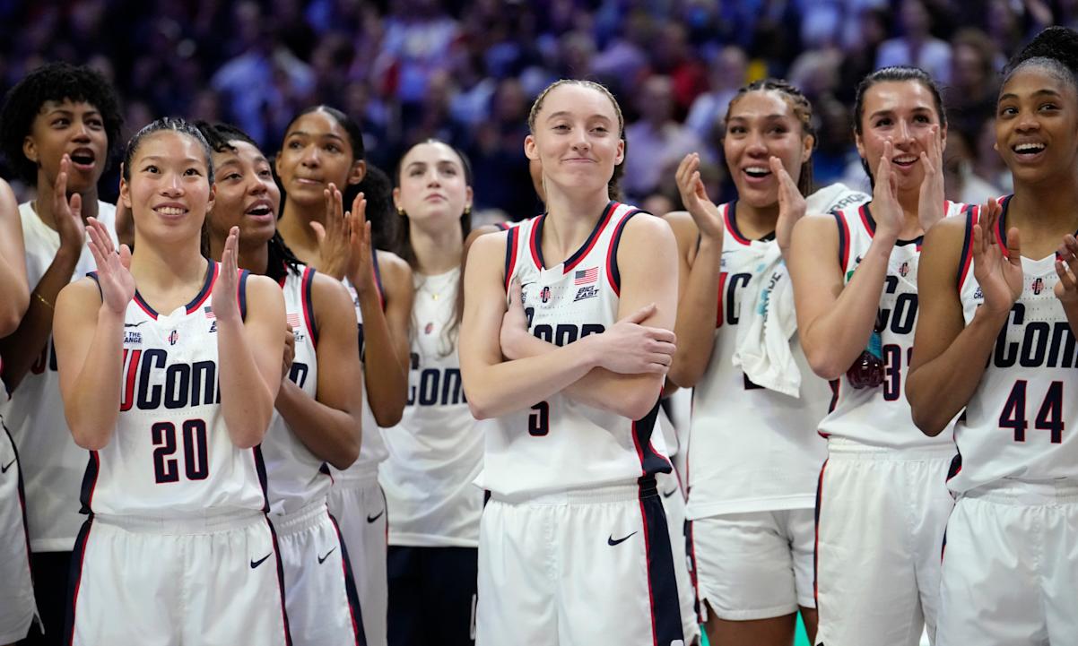 Paige Bueckers #5 of the Connecticut Huskies reacts as she is inducted into the Huskies of Honor program following an NCAA women's basketball game against the Marquette Golden Eagle