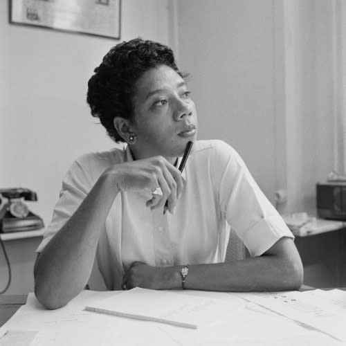 women sitting at desk contemplating