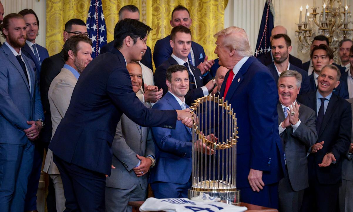 The Commissioner's Trophy is visible as Shohei Ohtani of Los Angeles Dodgers greets U.S. President Donald Trump 