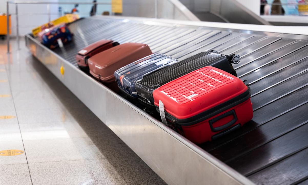 Luggages on Conveyor belt in the airport - stock photo