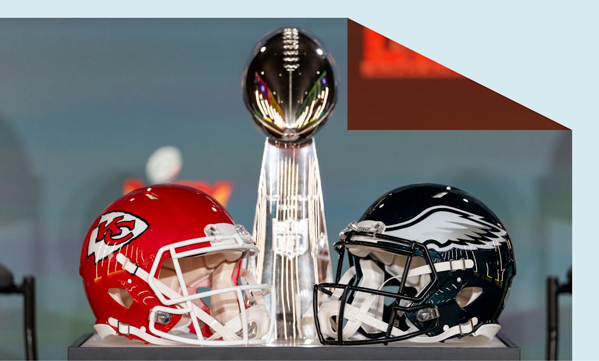  detail shot of the Lombardi Trophy next to Kansas City Chiefs and Philadelphia Eagles helmets