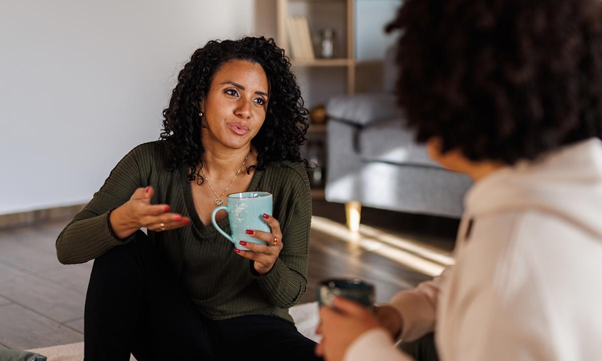 Two woman talking with coffee