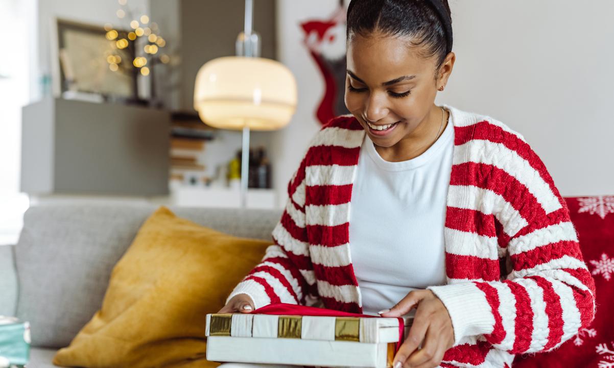 Woman opening holiday gift