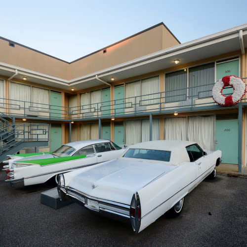 hotel with cars parked in front