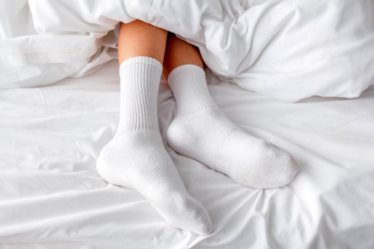 Someone wearing socks to sleep 