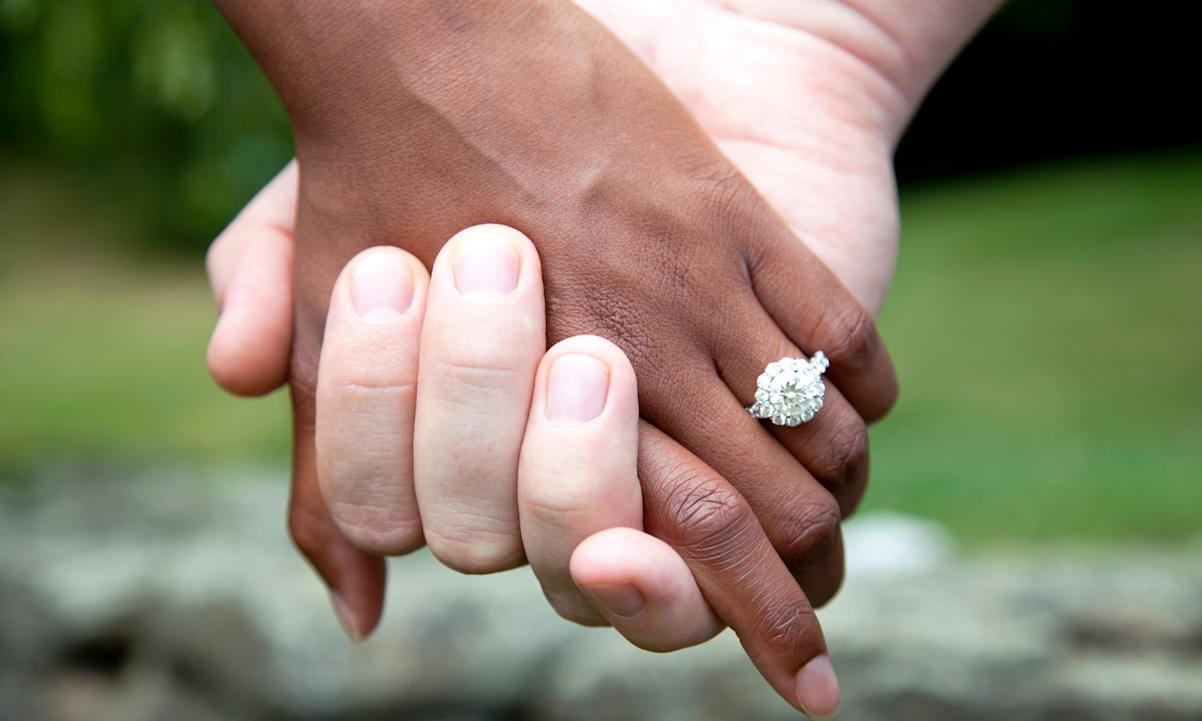 Engaged couple holding hands 
